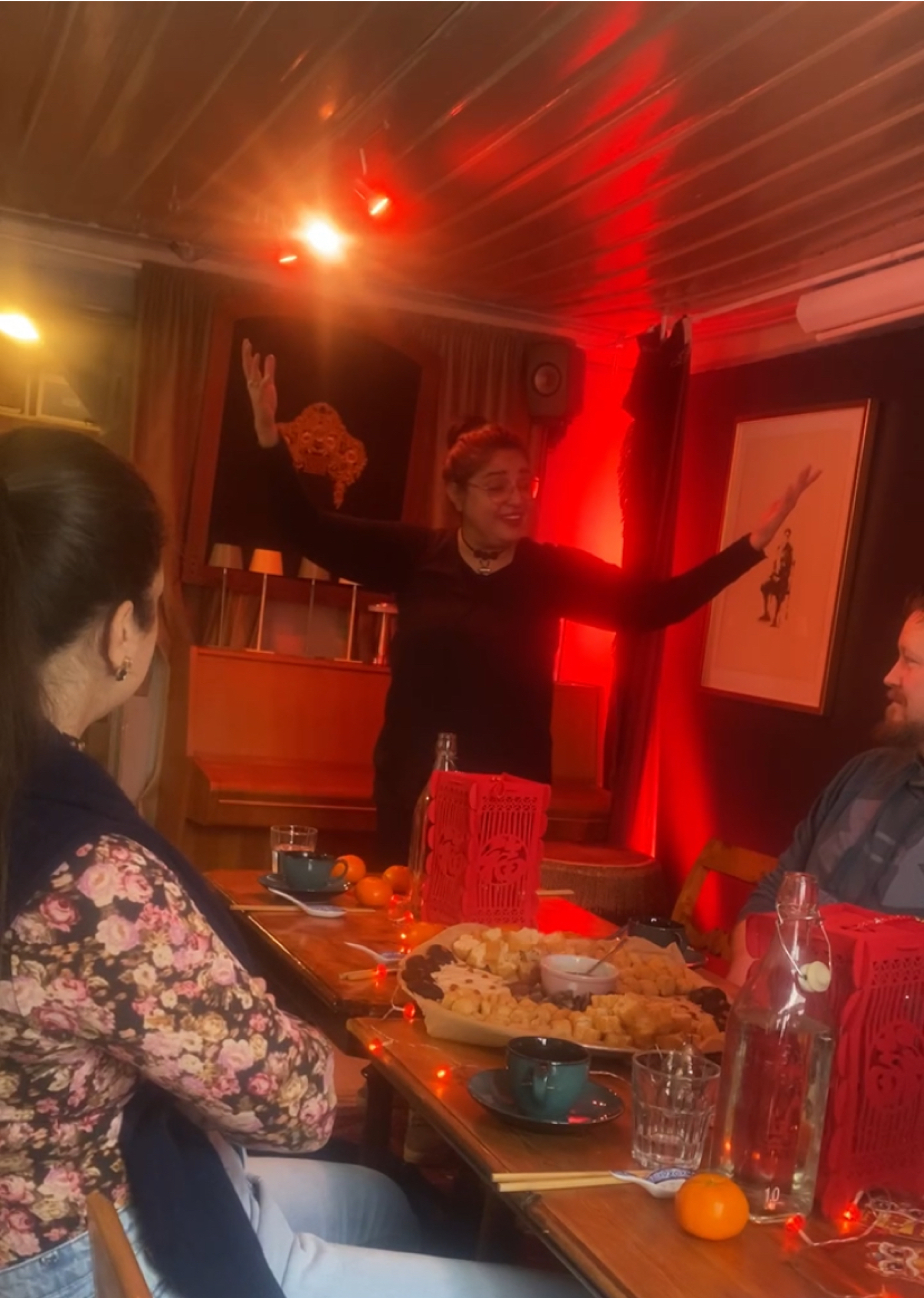 Community storytelling gathering around shared food and conversation.