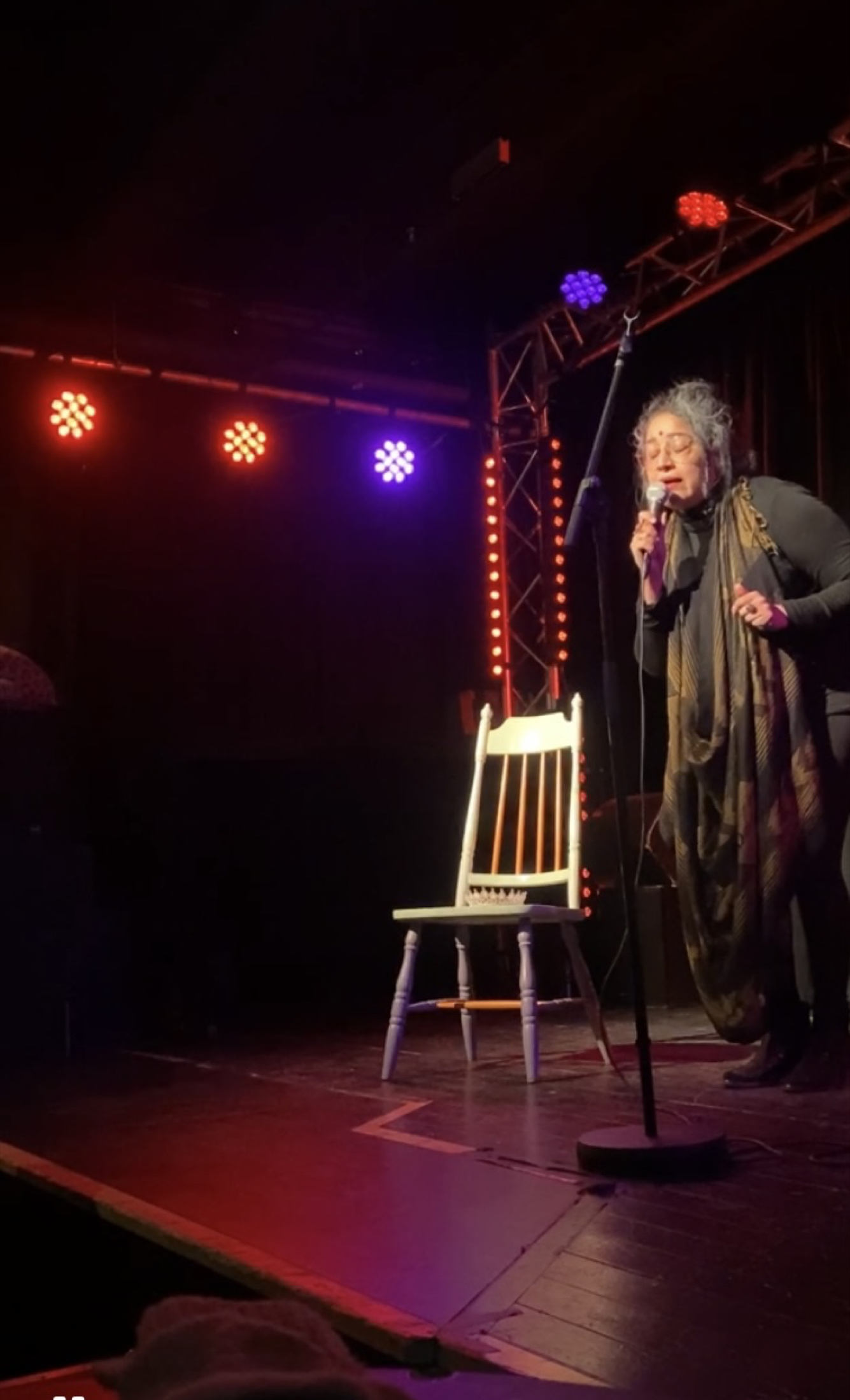 Portrait-oriented performance frame with dramatic contrast.